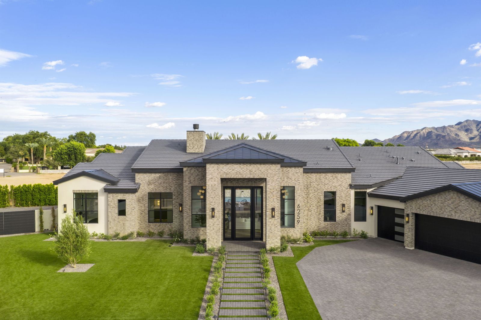 Twilight front elevation of the Key Biscayne Residence, a new custom home for sale in Gilbert AZ