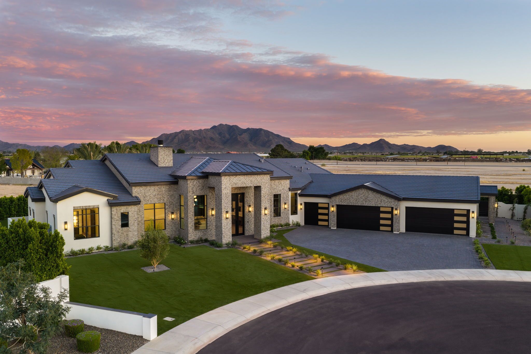 Twilight aerial view of 6259 S Key Biscayne Ct, Gilbert AZ, with the San Tan Mountains beyond
