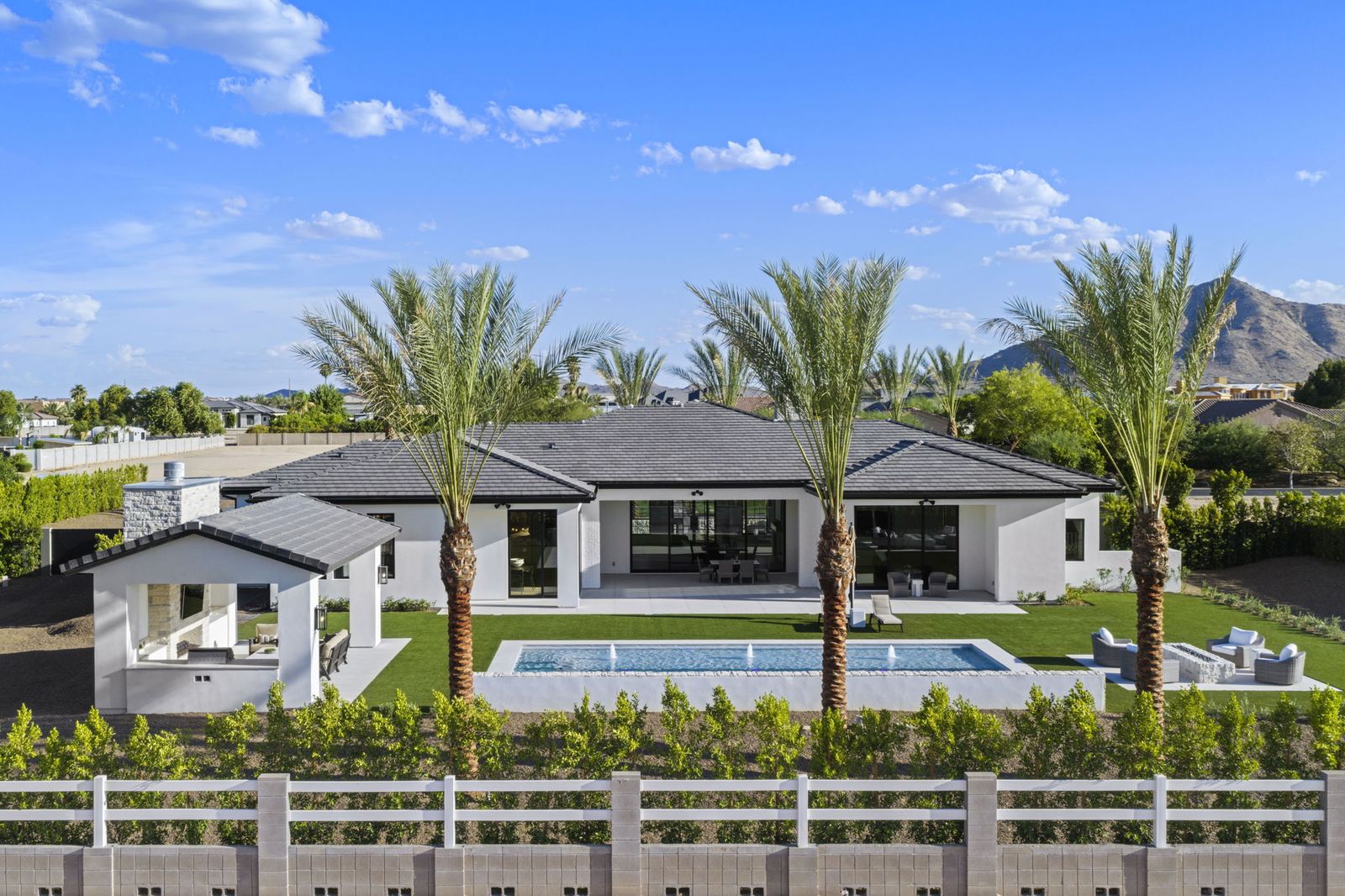 Aerial view of a completed Prestige Build Co. custom home with pool and palms