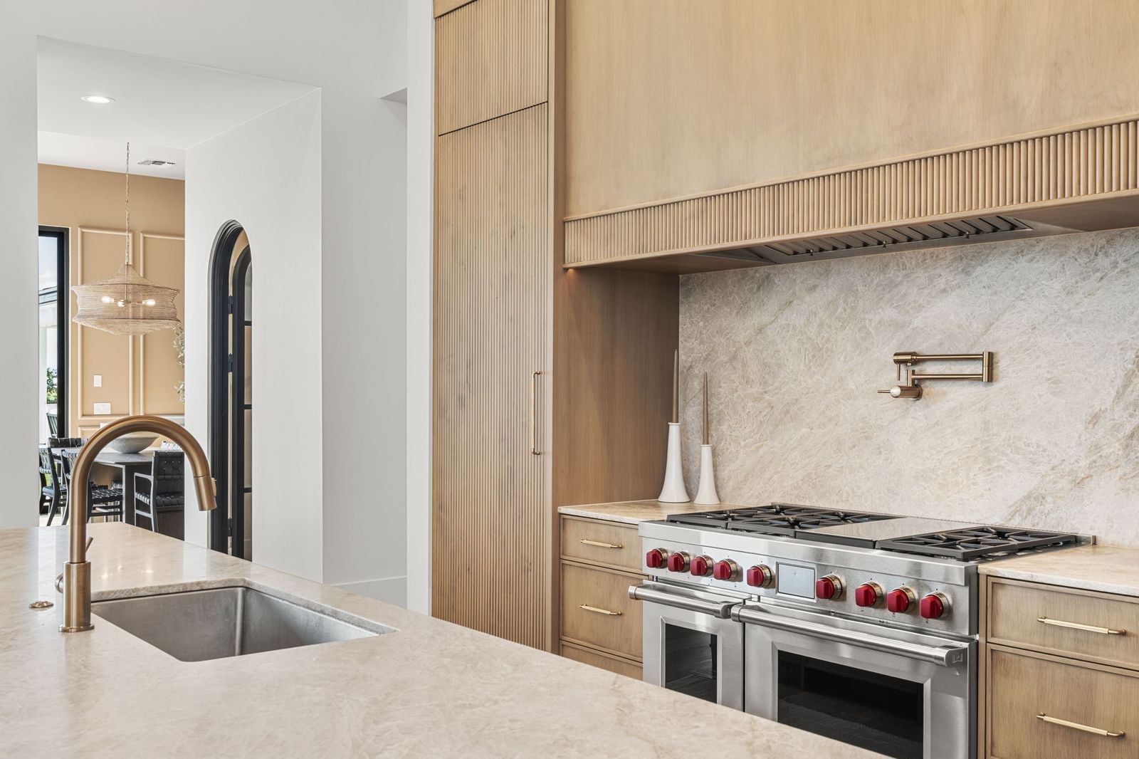 Wolf range and marble backsplash in a Prestige Build Co. custom kitchen